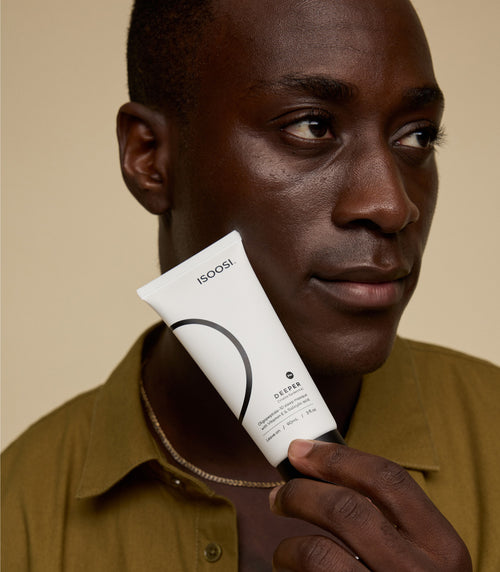 isoosi skincare model holding deeper tube